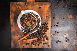 Fototapeta Mapy - Coffee beans in the cup on the table