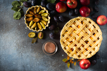 Wall Mural - Autumn and summer pie with apple plum on dark  background