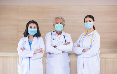 Group of doctors in uniform with mask looking at camera, group of medical staff at hospital, doctors team standing together.  corona virus concept.