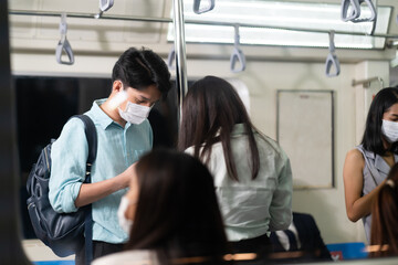 Wall Mural - Crowd of passengers on Urban Public Transport Metro. .Asian people go to work by public transport. Face Mask protection against virus. Covid-19, coronavirus pandemic