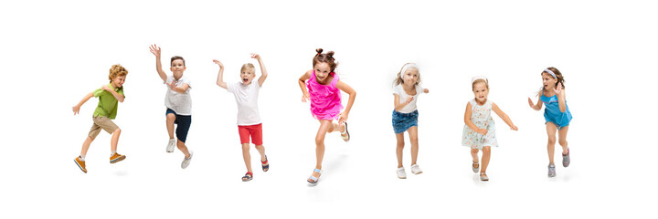 Wall Mural - Happy children, little and emotional caucasian kids jumping and running isolated on white background. Looks happy, cheerful, sincere. Copyspace for ad. Childhood, education, happiness concept.