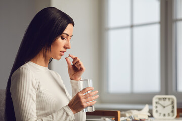 Pills tablet in hand of the girl in the room. Concept virus cold pill sick flu sickness headache flu illness