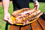 Fototapeta Dmuchawce - barbecue in summer time with meat and  sausages  in green garden