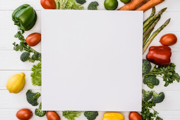 Wall Mural - top view of fresh ripe vegetables and fruits near empty square placard on wooden white background
