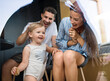 © Halfpoint - Young woman with husband and baby indoors, weekend away in container house in countryside.