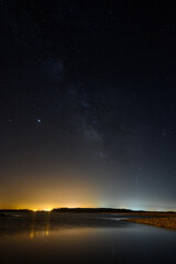 Sticker - Beautiful vertical shot of a starry night sky over the sea-perfect for wallpapers