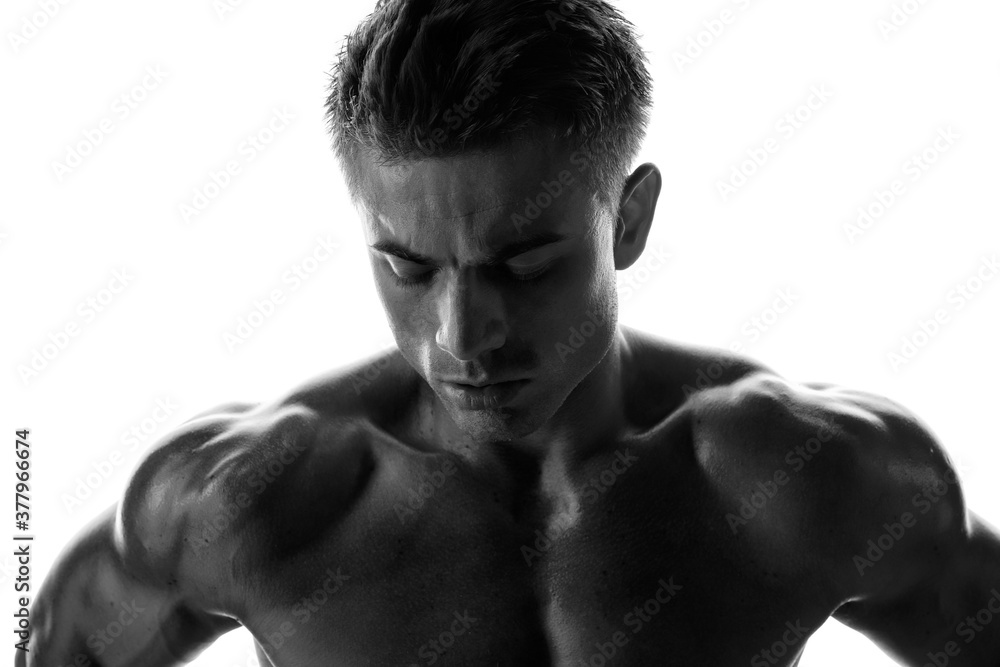 Muscular model sports young man on white background. Black and white ...
