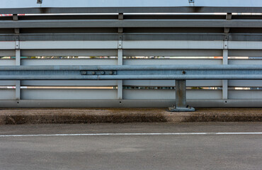 Wall Mural - Fence and road railing at a parking lot.