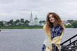 © Irida - A girl stands on the pier in a yellow scarf. Sea shore.