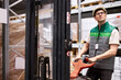 © Roman - young caucasian warehouse worker with hand pallet truck with package shipment sending to customers, in store