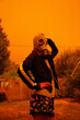 woman in gas mask against orange sky