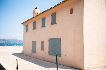 View of the old and stained wall of a house with windows shut down