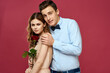 © SHOTPRIME STUDIO - Lovers people with rose in hands on pink isolated background hug emotions happiness romance feelings