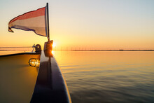 Beautiful Shot Of The Netherlands Flag On The Front Of A Boat During Sunset