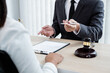 © Orathai - A male lawyer or a judge counseling clients about judicial justice and prosecution with scales, judges gavel, legal documents legal services concept