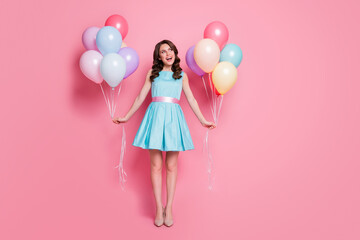 Wall Mural - Full size photo of pretty lady festive event prom party hold both arms many air balloons dreamy look empty space wear blue mini dress skirt high-heels isolated pastel pink color background