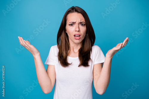 WTF. Photo of attractive pretty angry mad lady bad mood raise arms uncomfortable situation impressed unfair judgment wear casual white t-shirt isolated blue color background