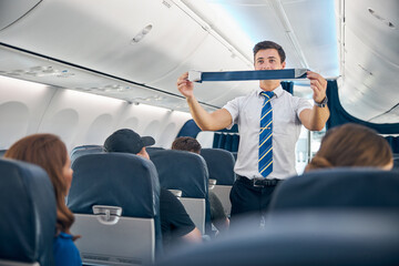 Handsome steward training safety prior procedures to flight take off