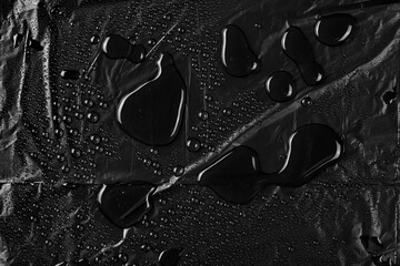 Wall Mural - Water droplets on black nylon bag background and texture