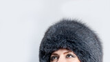 Fototapeta  - portrait of a woman in fur hat with grey smkey eyes makeup 