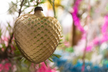 Vintage yellow glass decoration heart on the Christmas tree, retro toy from 70th