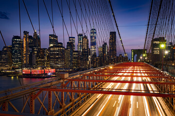 Fototapete - Lower Manhattan skyscrapers at Dusk and Brooklyn Bridge with light trails. Evening in New York City, NY, USA