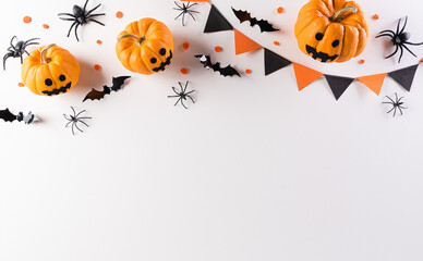 halloween decorations made from pumpkin, paper bats and black spider on white background. flat lay, 