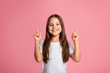 Emotions of happy preschooler. Funny little kid shows two fingers up at copy space