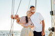 © Artem Varnitsin - Happy mature couple embracing each other and looking away. Two people standing on sailboat and smiling.