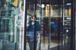 © BullRun - Serious man exiting from rotating doors