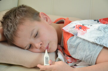 Sick Teenager with Thermometer in the Bed. fever, virus