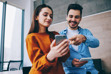 Wall Mural - happy hipster guys connecting to indoors wifi internet for reading publication content text via mode