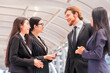 © shine - Group of business people. Business people discussing about a meeting while standing in the city.