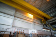 Part of an overhead crane in the background of an industrial workshop