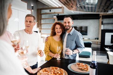 Wall Mural - Happy couple is posing at camera and holding wine