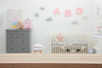 Poster - Empty wooden table in baby room. Space for text