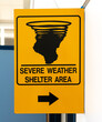 Yellow sign indicating a severe weather shelter area