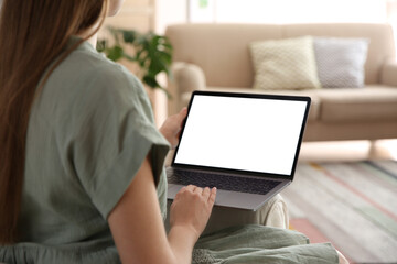 Woman using laptop at home, closeup. Space for design