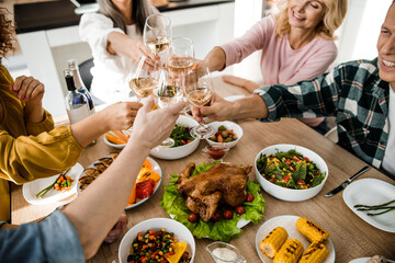 Wall Mural - Cheerful people celebrating thanksgiving day together at home