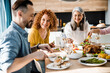 © Yakobchuk Olena - Happy guests at the festive table in the house