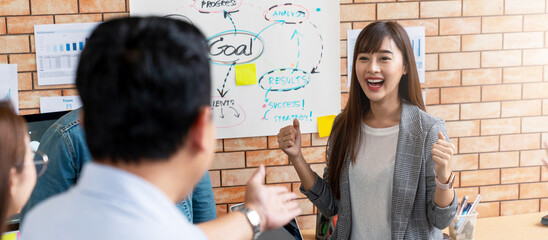 Banner or header of happy beautiful young asian businesswoman excited with win reward from boss in small meeting in corporate workforce reskill upskill concept. Joyful promote staff or employee.