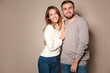 © New Africa - Lovely couple in warm sweaters on beige background