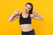 © ViDi Studio - Puzzled confident young fitness sporty woman 20s in black sportswear posing training working out pointing thumbs on herself looking camera isolated on bright yellow color background studio portrait.