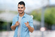 © Daniel Ernst - Laughing hispanic hipster man with beard and casual clothes