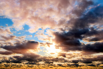 Wall Mural - cloudscape on sunset sky landscape background. natural color of dark clouds. blue sky. golden sunset