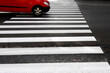 image of a red car at a crosswalk