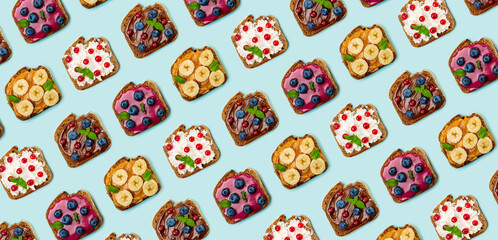 Sticker - Pattern with set of different sweet sandwiches: with chocolate butter, peanut butter, soft cheese, berry curd, decorated with fruits and berries. Light blue background. Top view. Flat lay.