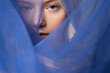 Charming young woman wearing beautiful blue veil