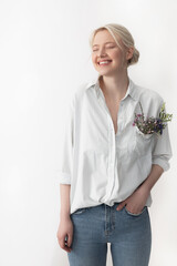 Wall Mural - Cheerful young woman standing against white background