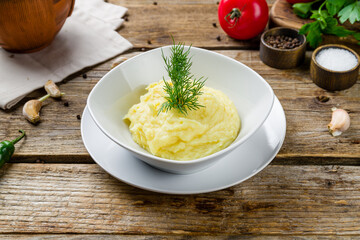 Wall Mural - mashed potatoes on bowl on old wooden table